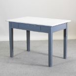 A cream and grey painted dining table,