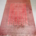 A Bokhara woollen carpet on red ground,