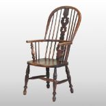 An early 19th century elm seated windsor armchair,