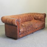 A tan leather button upholstered chesterfield sofa,