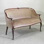 A 1920's brown upholstered show frame sofa on cabriole legs,