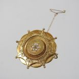 A 15 carat gold and split pearl brooch, of star shape, with a pin back and safety chain,