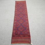 A Turkish woollen runner, with five central diamond pattern, on a blue ground,