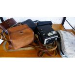 A small collection of various vintage cameras, comprising a Rollei 35s with flash and booklet;