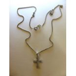 An 18ct white gold and diamond cross on 18ct white gold chain,
