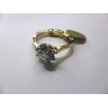 A 14ct gold and diamond floral cluster ring with gold-plated hinged shank, approx. 0.33ct total,