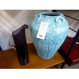 A pale blue terracotta urn together with a purple glass pitcher (2)