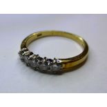 An 18ct gold and diamond five stone ring, total 0.38cts, ring size N.,