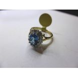 A 9ct gold, topaz and diamond cluster ring