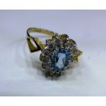 A 9ct gold, topaz and diamond cluster ring