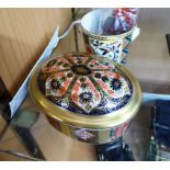 A boxed Crown Derby miniature champagne bottle and ice bucket together with an Imari lidded pill box