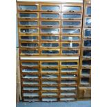 A pair of vintage oak haberdasher's or habersdashery cabinets with glass front drawers (2)