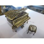 A Continental miniature silver musical grand piano and stool, the music box with clockwork key to