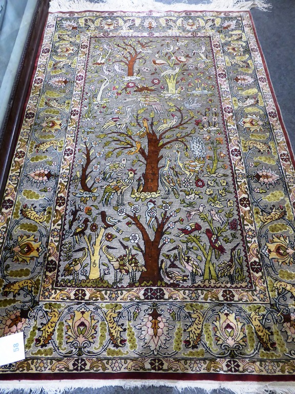 An Indian silk Tree of Life rug.