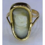 An antique 9ct gold and white stone ring with hidden face - possibly jade, late 19th / early 20th