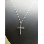 A platinum and diamond cross pendant on 18ct white gold chain