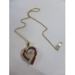 A 14ct gold and clear & red stone heart pendant on 10ct gold chain,