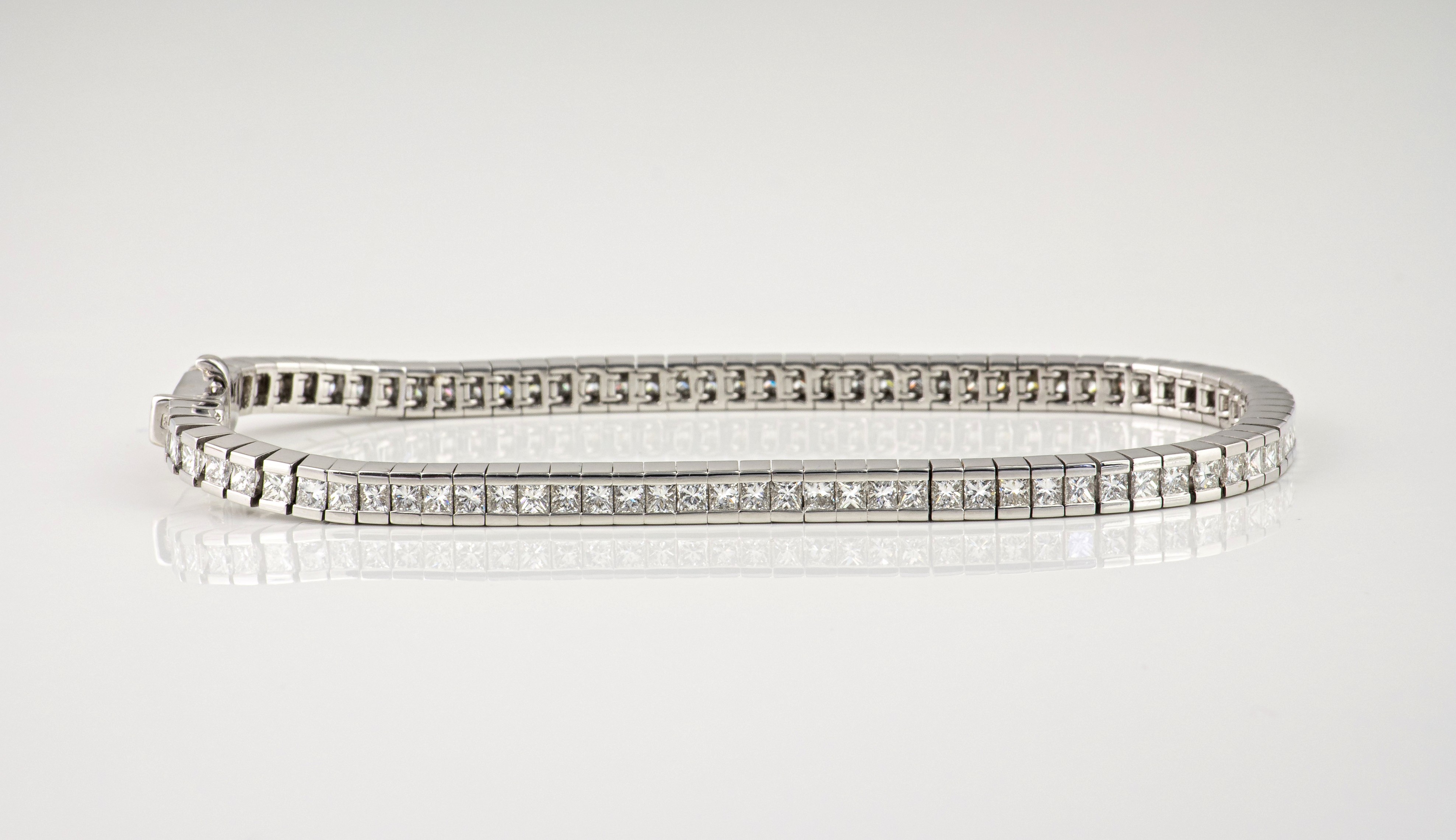 An 18ct white gold and diamond flexible tennis bracelet, the princess cut diamonds totalling 4.50ct,