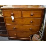 A Victorian mahogany chest of two short over three long drawers on bun feet.