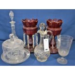 A pair of ruby glass table lustres and etched glass cheese dome, a claret jug, decanter and a celery