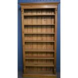 A seven shelf open pine bookcase 78in. (198.2cm.) high.