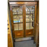 An Edwardian glazed mahogany display case inlaid with boxwood, satinwood and ebony. Square tapered