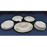 An Art Deco dinner service decorated with bright green and black geometric pattern comprising
