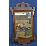 An early 19th century George II style mahogany fretwork mirror with rectangular plate and gilt slip,