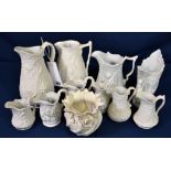 A collection of white biscuit porcelain jugs including Portmeirion and a Belleek vase (11)