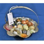 Two glass paperweights, a collection of stone eggs and mineral specimens in an EPNS breadbasket (