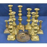 Five pairs of antique brass candlesticks all of similar design, varying sizes, the tallest, 11