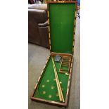 A late Victorian mahogany folding bagatelle board and accessories the interior with green baize,