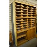 A mid twentieth century haberdashery unit, two cupboards with sliding doors and forty sliding