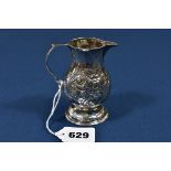 A George II silver baluster cream jug London 1736, maker's mark indistinct, with later Rococo scroll