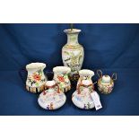 A pair of Japanese porcelain twin handled vases together with a Chinese lamp base, three graduated