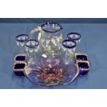 A retro purple glass pansy dish, four blue Murano glass salts and a Micky Mouse etched water jug