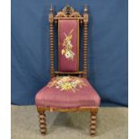 An early Victorian rosewood prie dieu chair with pierced top rail over padded back splat and seat,