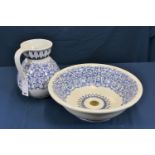 A Victorian large blue and white jug and basin with floral decoration, the basin with fitted brass