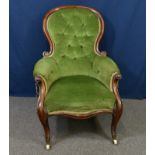 An early Victorian walnut showframe armchair the buttoned balloon shaped back over scroll arms