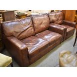 A brown leather two seater sofa with matching club chair (2)