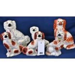 A collection of six ceramic Staffordshire spaniels, one with flower basket (6)