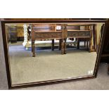 A bevelled glass mirror in wooden frame (75cm x 49.7cm)