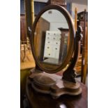 A Victorian mahogany oval swing mirror