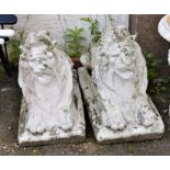 A pair of decorative concrete garden statues of lions, approximately 70cm long