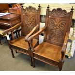 A pair of c.1900 carved oak 17th century style back stools