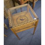 A glass topped side table with stencilled design.