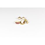A yellow gold and ruby or garnet ring with central oval cut and six round cut stones, ring size I,
