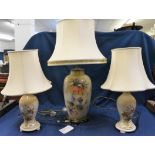 A large ceramic table lamp with hydrangea/raspberry/butterfly decoration together with a pair of