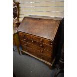 A George III mahogany bureau with fall front and fitted interior over four graduated drawers,
