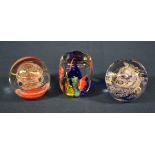 Three glass paperweights of varying sizes and shapes, one etched, 'Sark Glass'. (3)